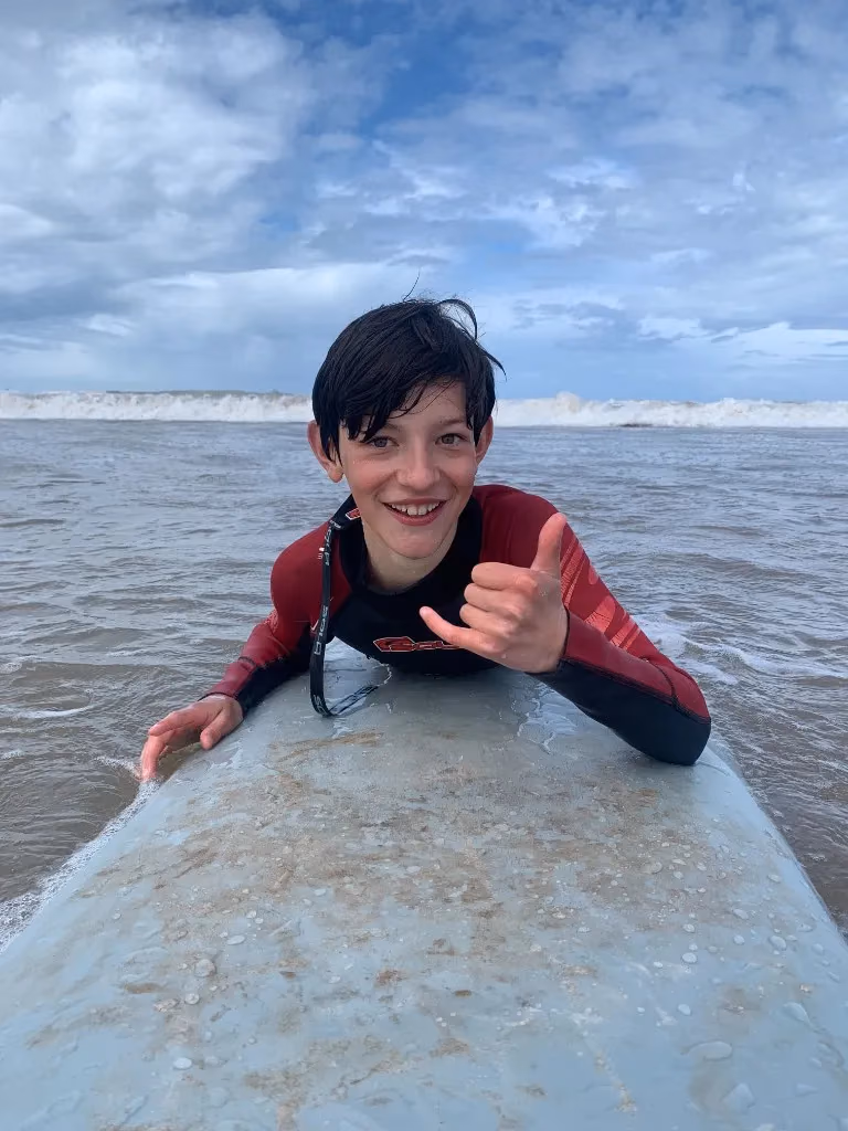 Young surfer learning on Essaouira beach, Morocco